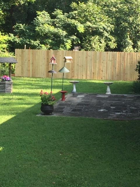 Wood privacy fence with decorative post caps