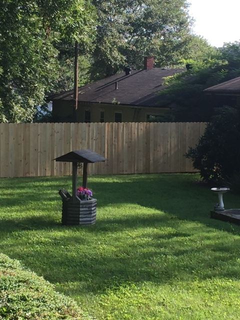Solid wood privacy fence enclosing a yard