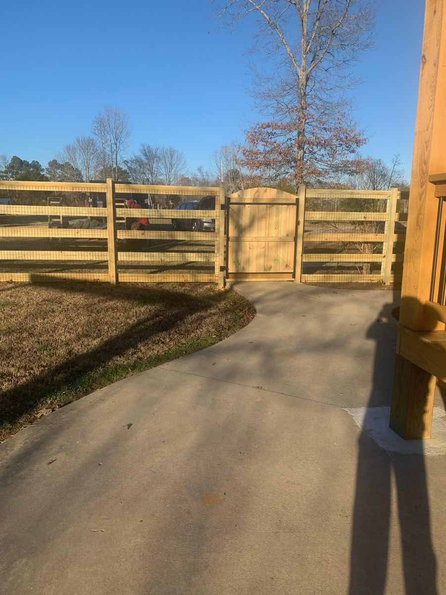 Custom wood fence with an automated sliding driveway gate