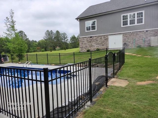 Ornamental aluminum fence around a swimming pool